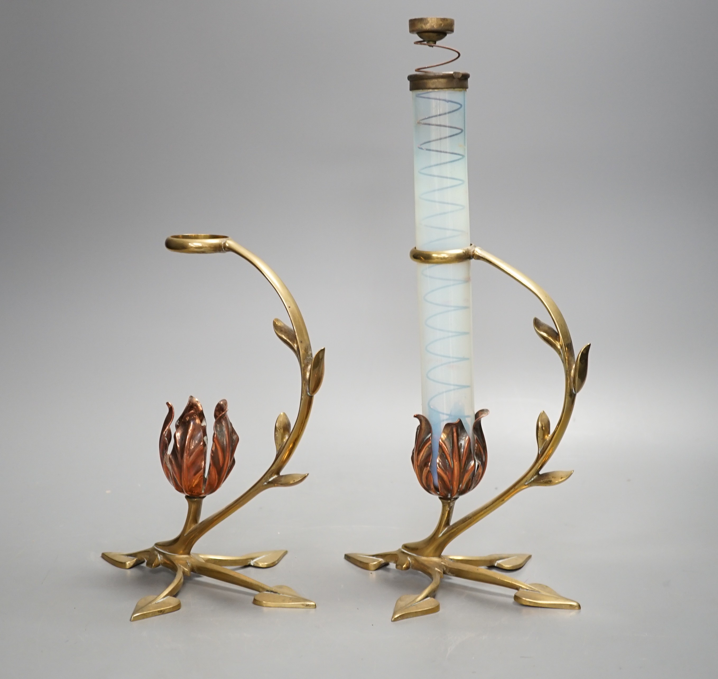 Attributed to W.A.S. Benson, a pair of brass and copper cradle lamps, one with original vaseline glass shade with candle ejector. Total height 31cm